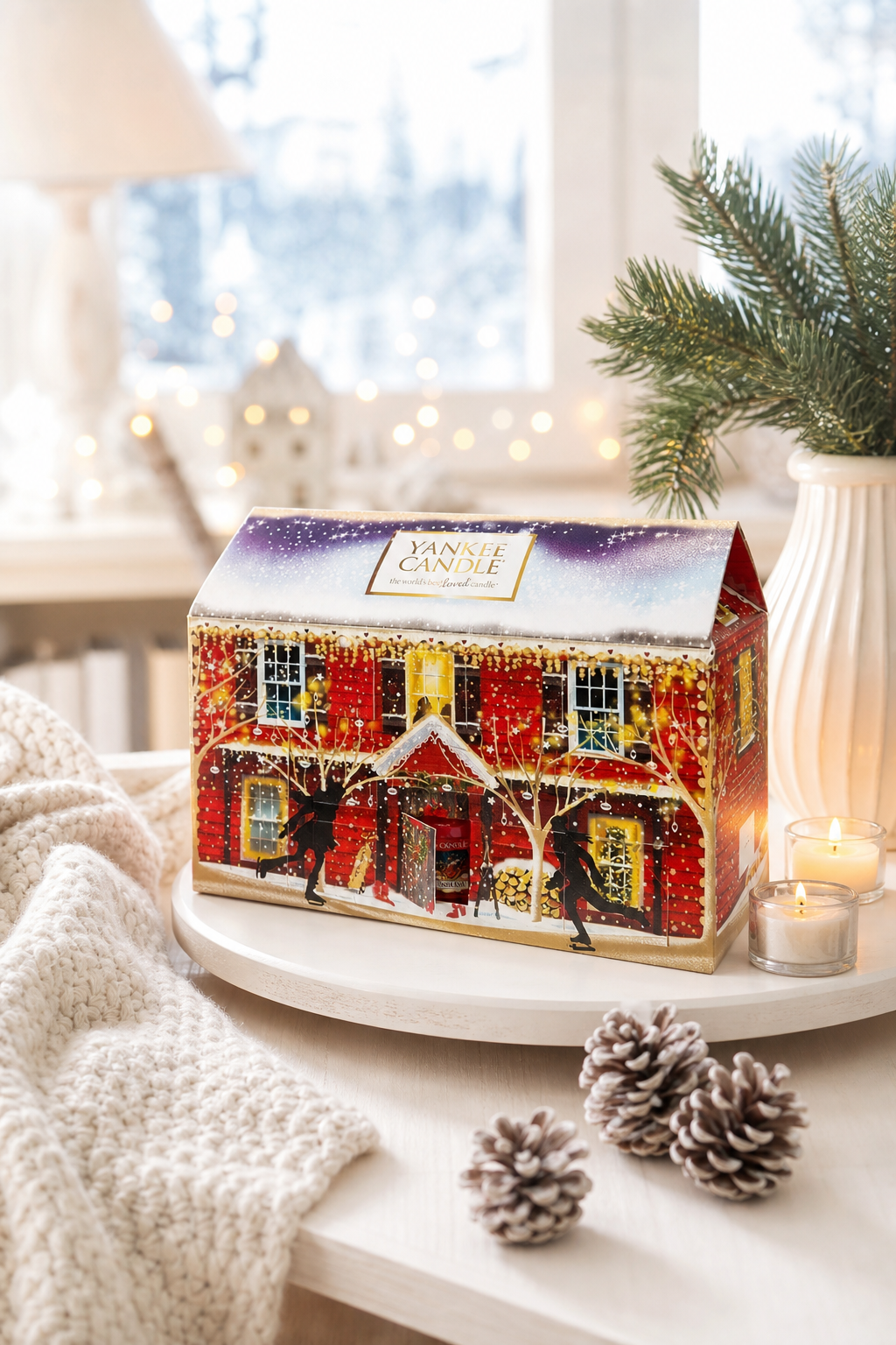 Yankee Candle Adventskalender Haus auf Tisch mit Tannenzweig und Kerze