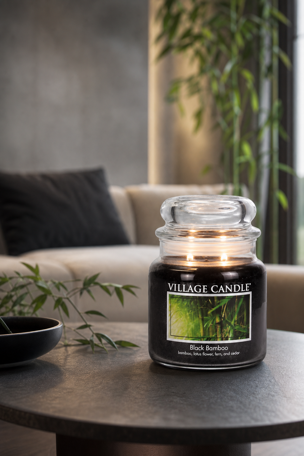 Brennende Black Bamboo Kerze im Glas auf einem Wohnzimmertisch