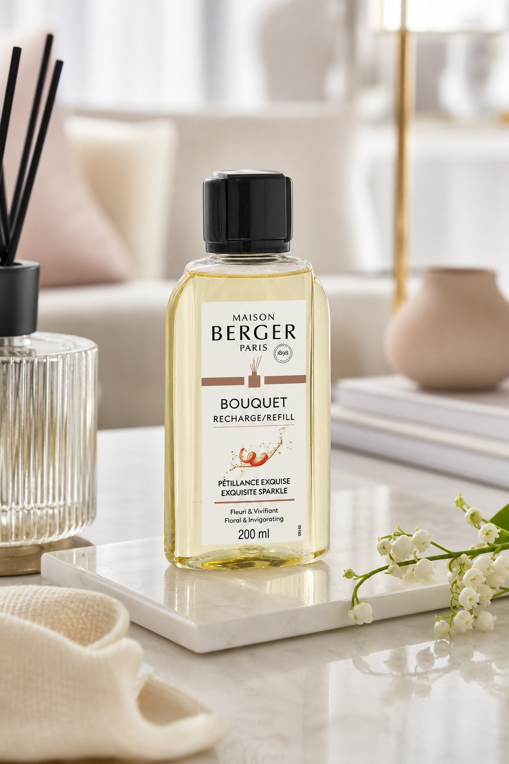 Maison Berger Paris Bouquet Nachfüllflasche auf einem Tisch neben Duftstäbchen