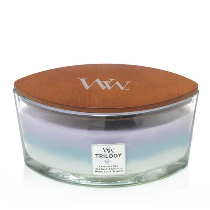 Glasbehälter mit braunem WoodWick-Deckel und Trilogy-Etikett