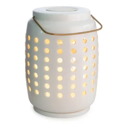 Weiße Duftlampe mit beleuchteten runden Öffnungen und goldenem Bügel