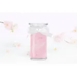 Rosa Kerze im Glas mit weißer Schleife und Kirschblütenmotiv