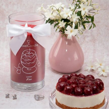 Cherry Kiss Kerze neben Kirschkuchen und rosa Vase