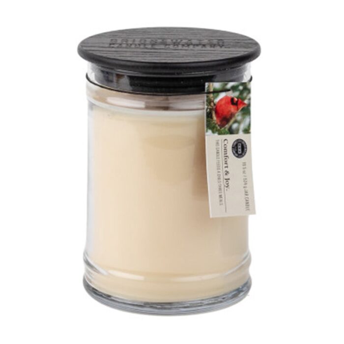 Creamfarbene Kerze im Glas mit schwarzem Deckel und rotem Vogel auf dem Etikett