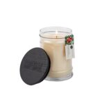 Brennende Comfort & Joy Duftkerze im Glas mit abgenommenem schwarzem Deckel