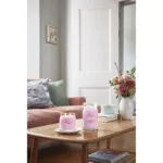Yankee Candle Hand Tied Blooms Kerze neben einer weiteren Kerze auf Tisch