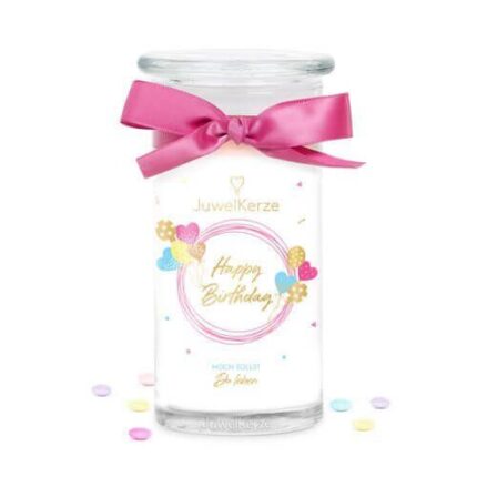 Happy-Birthday-Kerze mit rosa Schleife zwischen zwei dekorierten Geschenkboxen