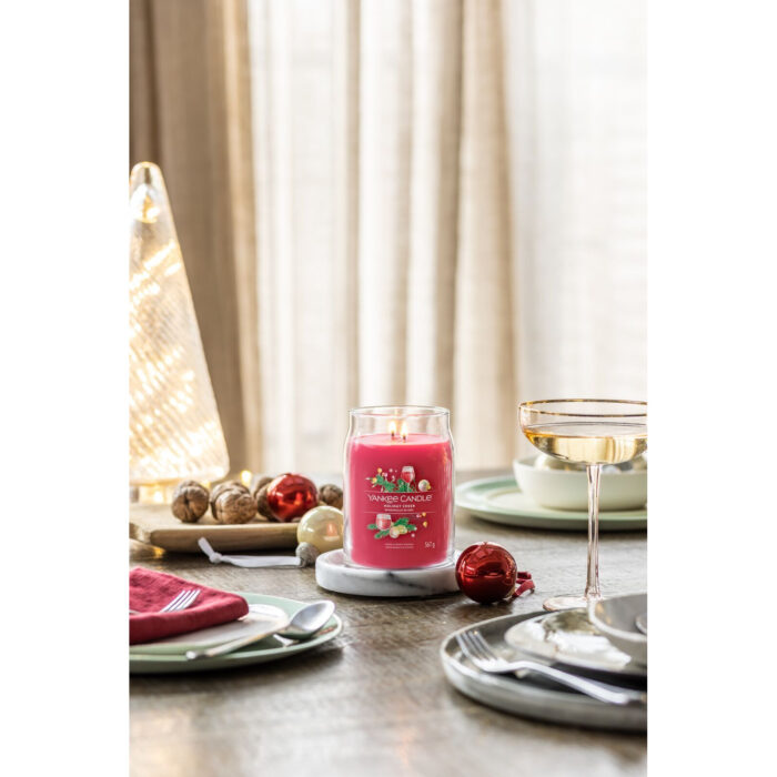 Mehrere Yankee Candle Kerzen mit Holiday Cheer Kerze auf einem dekorierten Tisch