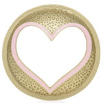 Nahaufnahme des goldenen Illuma-Lids mit rosa Herzrahmen und geprägtem Muster
