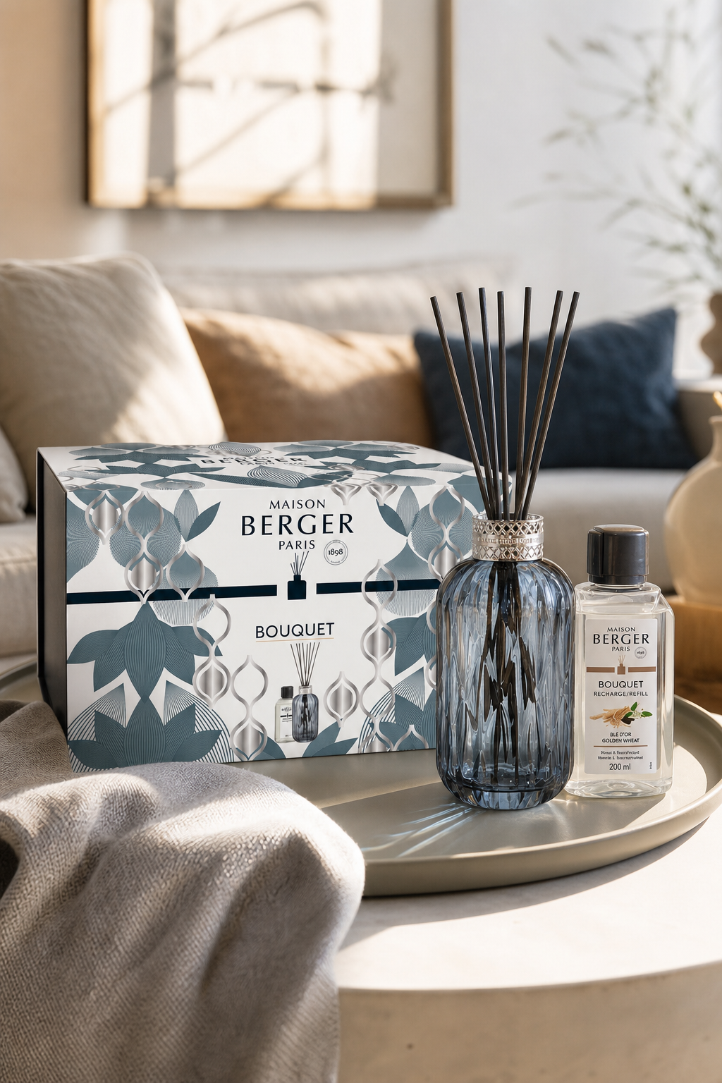Diffuser-Set mit Verpackung auf einem Wohnzimmertisch neben Sofa und Dekoration