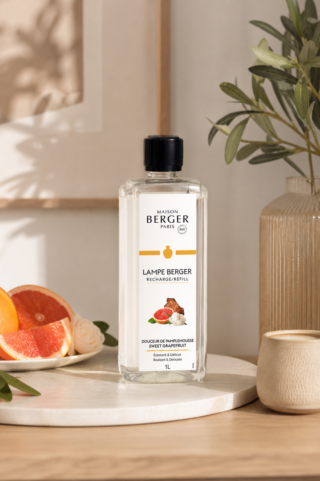 Maison Berger Nachfüller steht auf einem Tisch neben Grapefruit und Pflanze