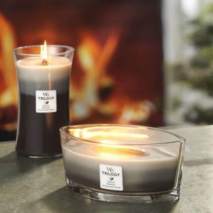 Zwei brennende WoodWick Trilogy Kerzen in unterschiedlichen Glasformen